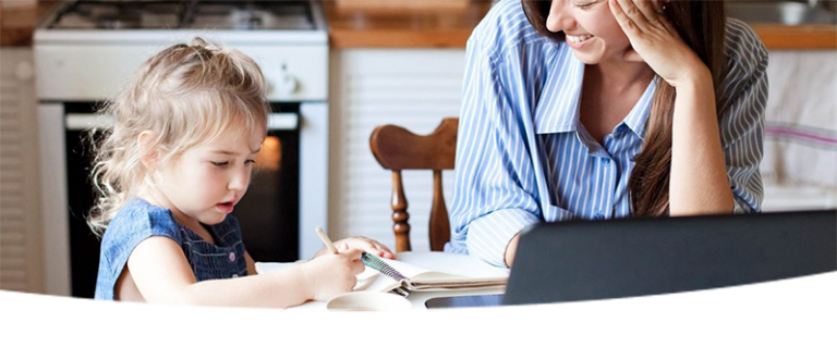 Mother with young child writing in a notebook
