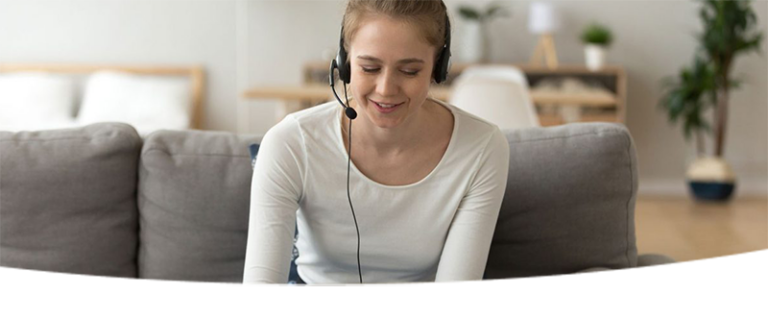 Woman wearing a headset attending a virtual meeting