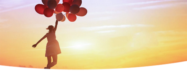 Woman holding up several balloons