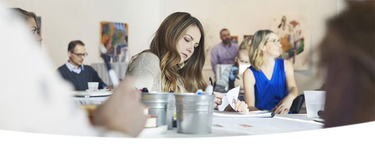Employees taking notes during presentation