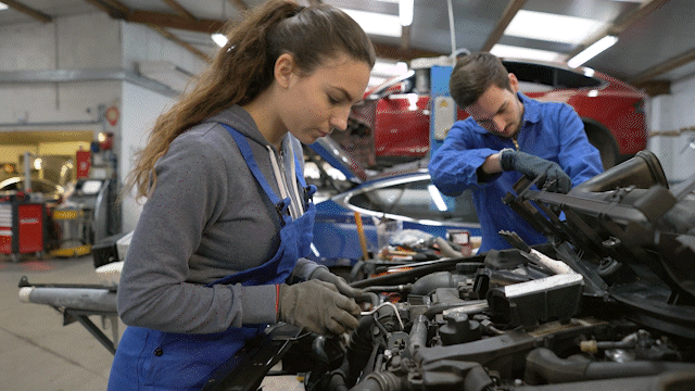 Female and male car mechanics